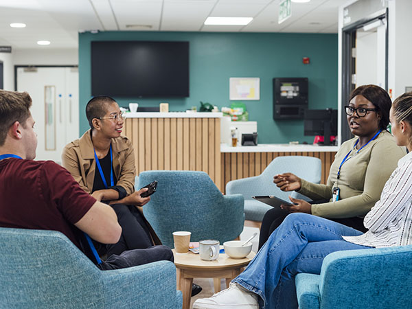 A group of providers having a discussion in a hospital setting. 
